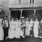 Irving students, costumed for a play, standing in front of Irving Hall ca. 1900