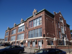 George Chandler Public School.  This 1907 school in the Fishtown neighborhood, designed by Henry deCourcy Richards, has been rehabilitated into The Chandler School Apartments.  Features like the original wood windows, wood doors, and copper gutters have been preserved.  Housing is the most popular re-use strategy for historic schools.