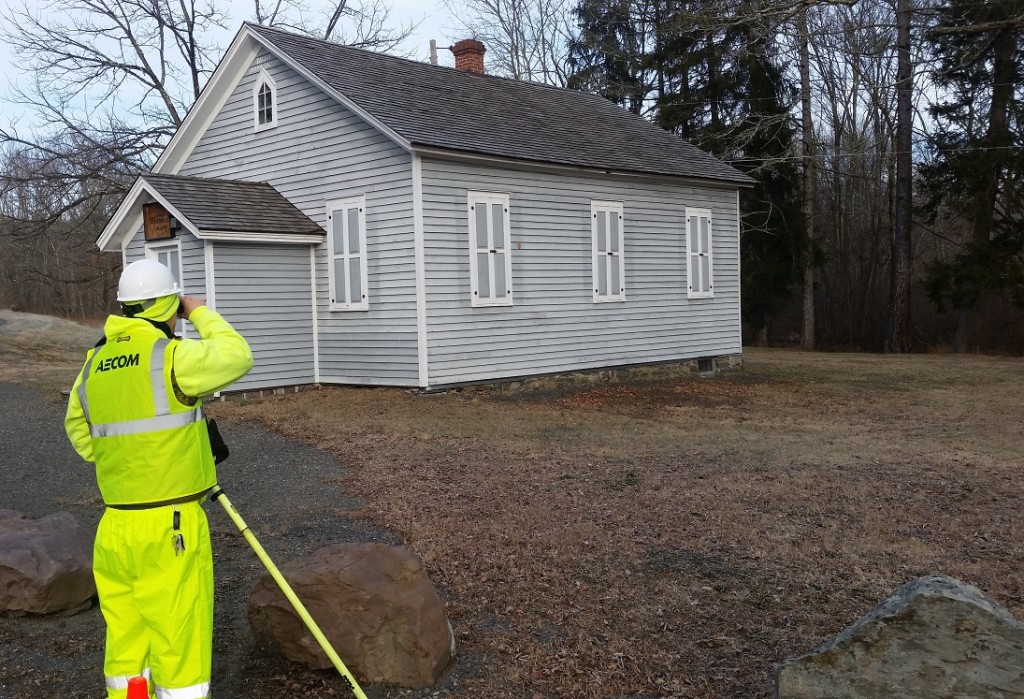 AECOM team member Raymond Dissinger collects detailed building elevation measurements for the former one-room Appenzell school house (circa 1840) in the area once known as “Jackson Corners” in Jackson Township, Monroe County. 