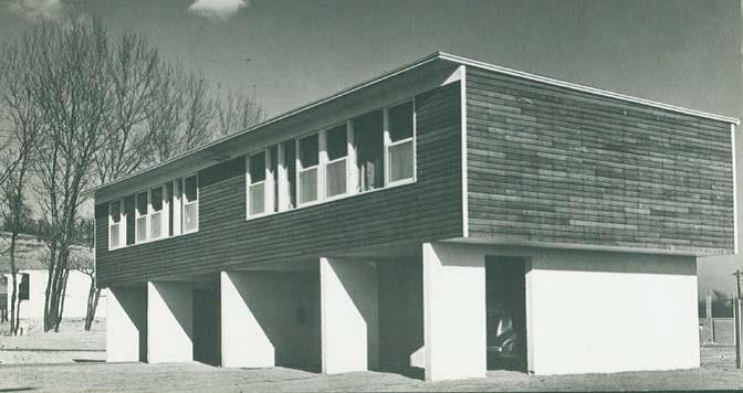 Historic view of the distinctive “C” type houses, designed with carports, utility rooms, and storage space on the first floor and living space on the second. The original wood siding has been replaced with vinyl or aluminum throughout the neighborhood, and some carport bays have been enclosed and converted to living space—an option intentionally made possible by the original design. Image courtesy of the Louis I. Kahn Collection, University of Pennsylvania Architectural Archives.