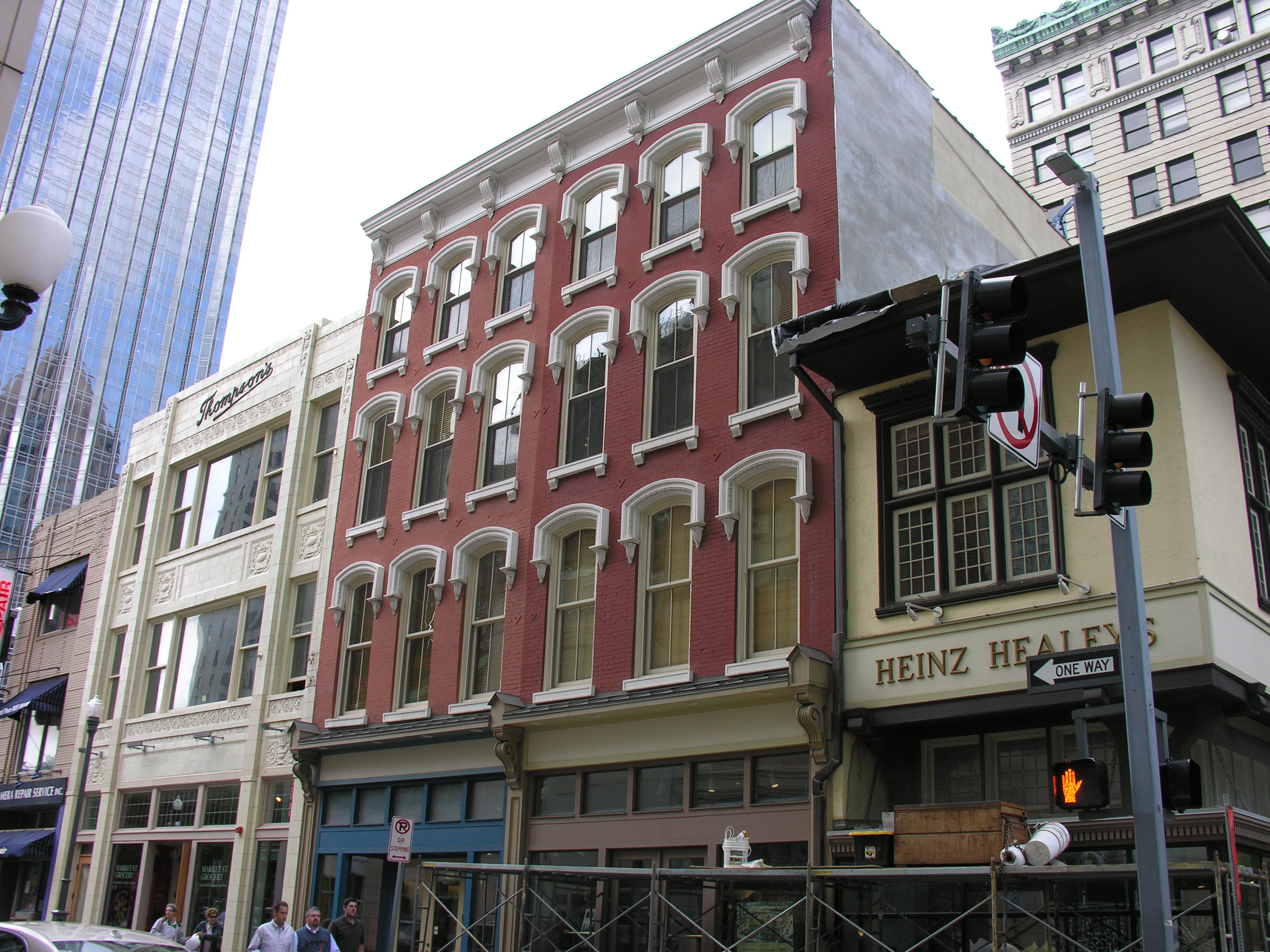 4-story brick buildings with storefront at street level.