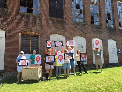 Preservationists stand outside of the Kiddie Kloes factory to say "This Place Matters"!