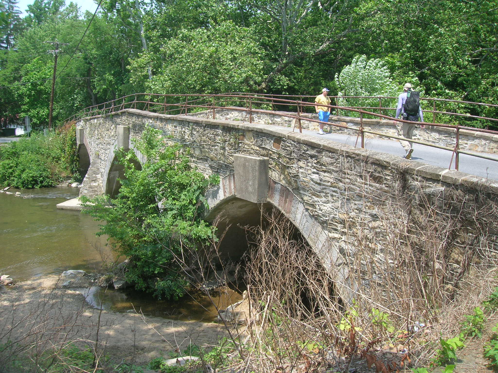 Hikers on stone bridge