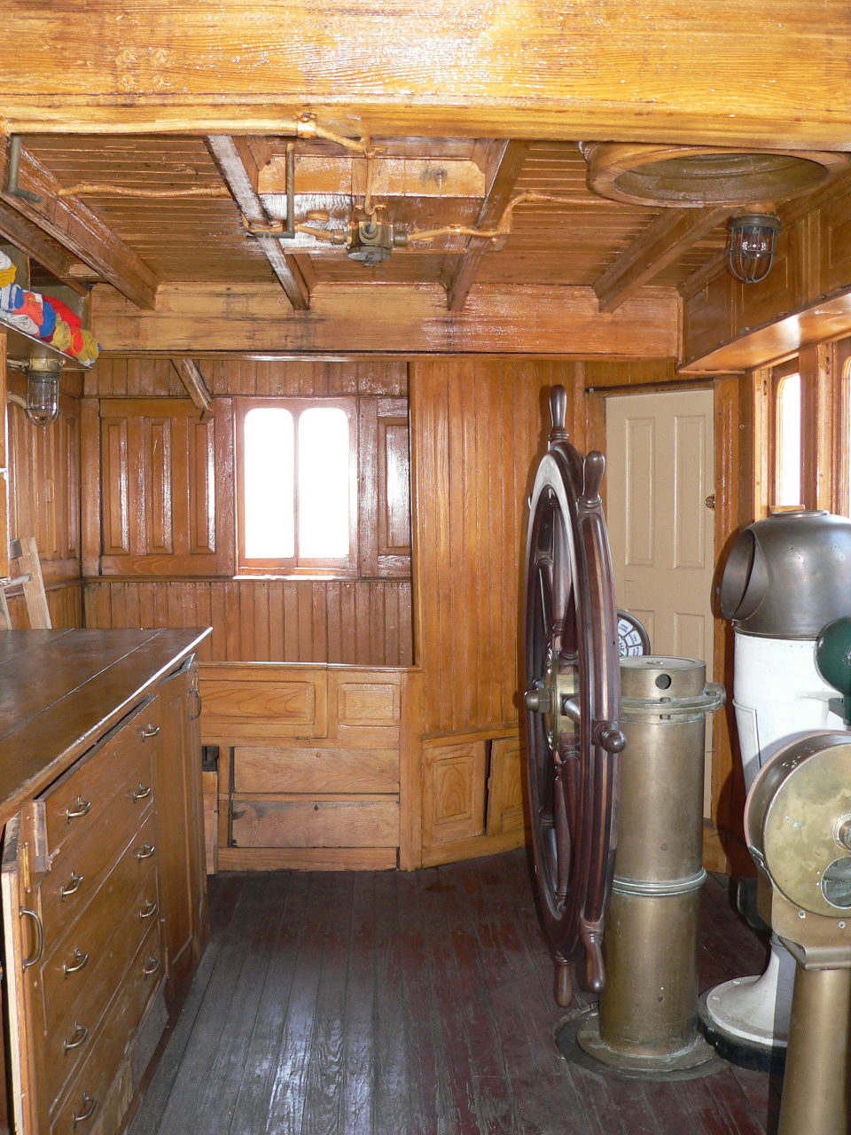 Room with wood panelling and metal machinery.