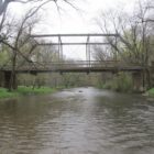 1905 short metal truss bridge over water