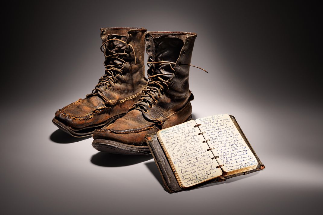 Early 20th century hiking boots and notebook