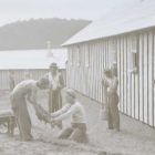 Historic photo of men working outside building.
