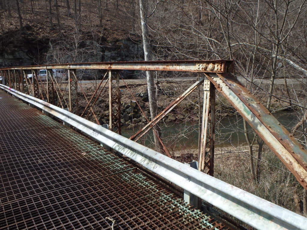 Metal truss bridge vertical center posts.