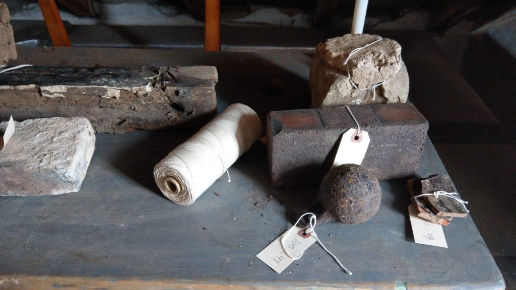 Brick, pottery, and iron ball on table