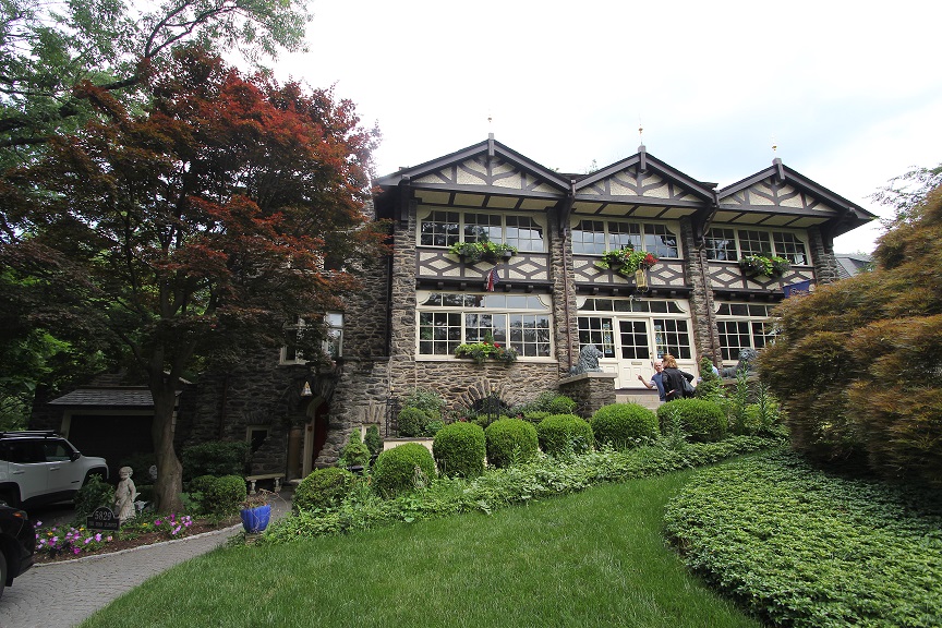 Large stone building with windows and landscaping.