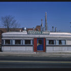 One-story metal building with sign that reads "Scotty's Diner"