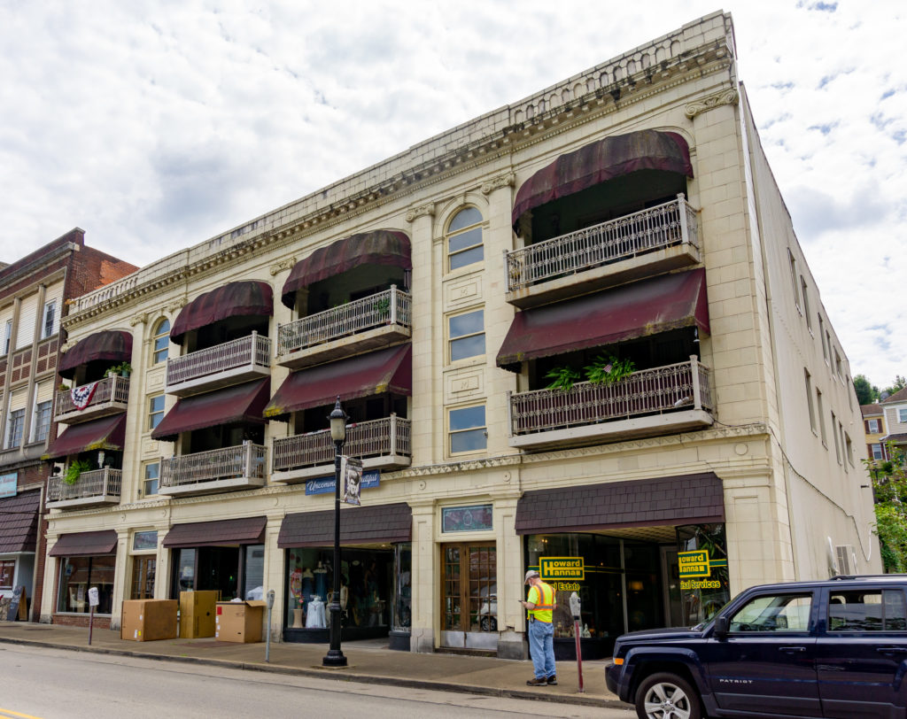 3 story building wiht balconies and awnings