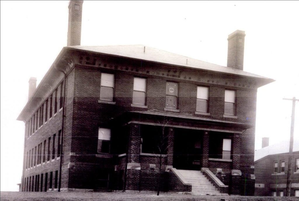 Black and white photograph of large brick building.