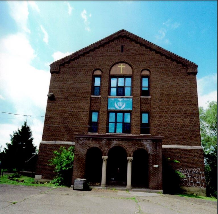 Large brick building with arched center entrance.