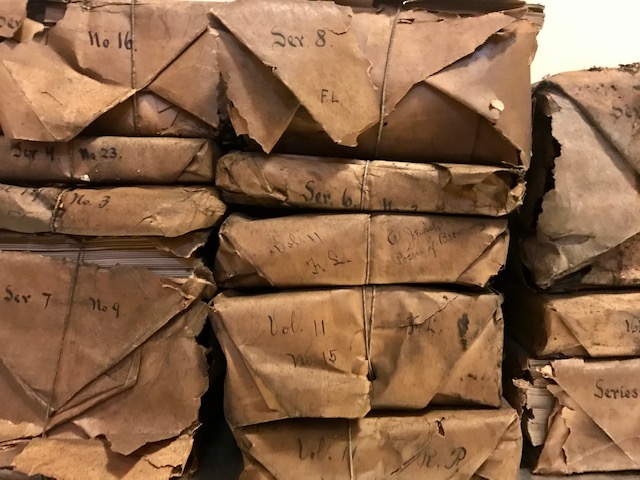 Stacked packages wrapped in brown paper and tied with string.