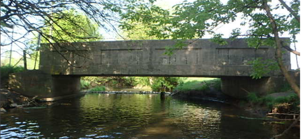 Concrete bridge over stream.