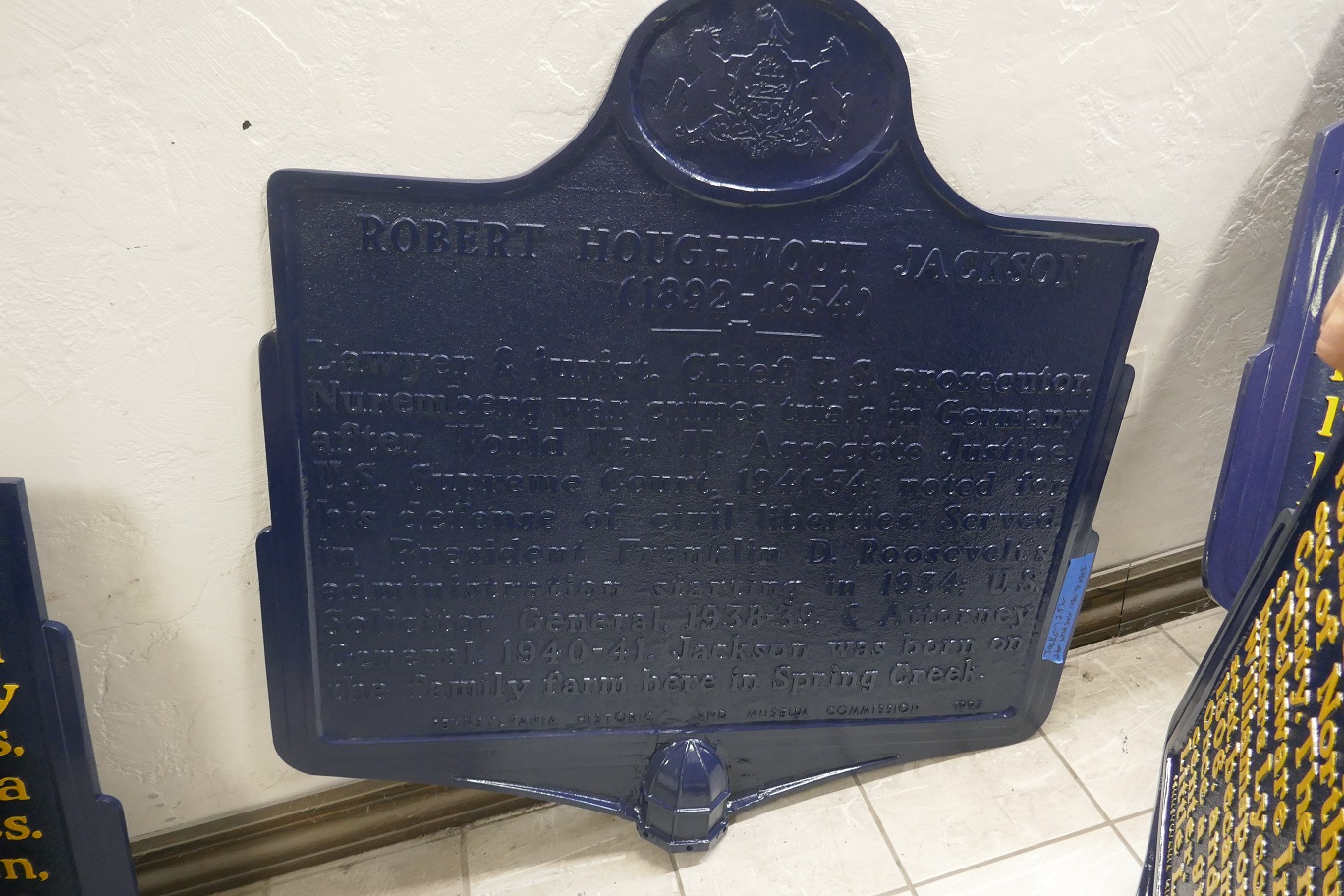 Large metal marker painted in dark shade of blue.