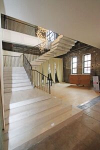 Large room with concrete stair.