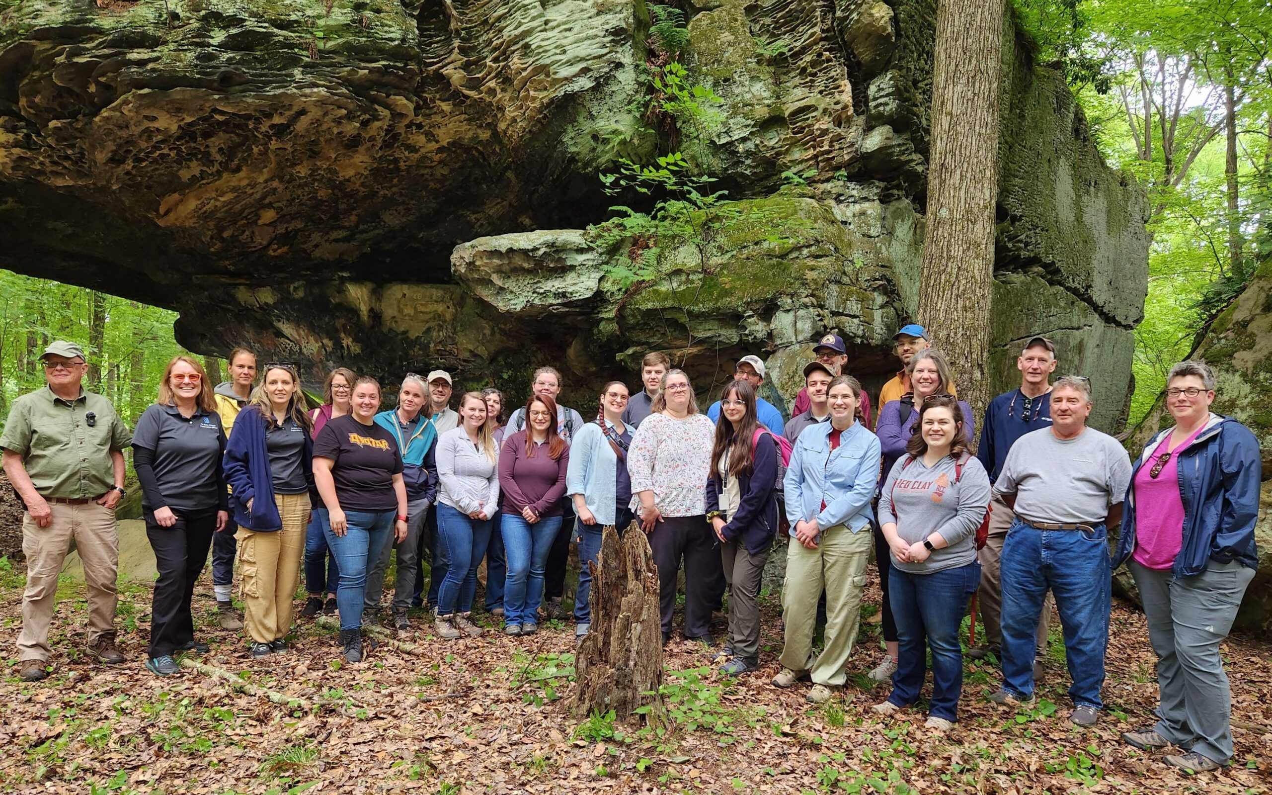 A group of people standing in a forest.