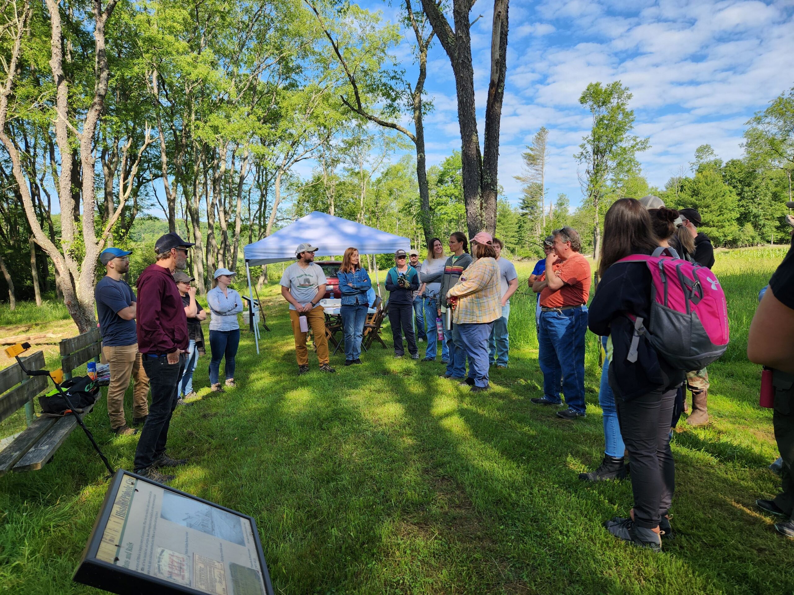 Large group of people standing in a field.