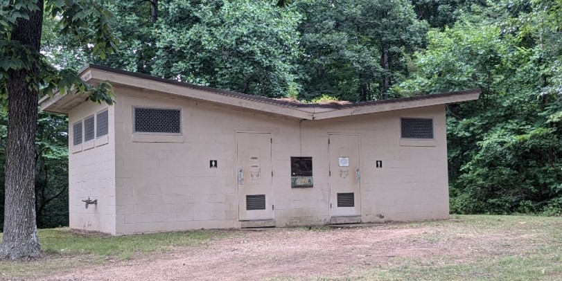 One story cement block building with v-shaped roof.