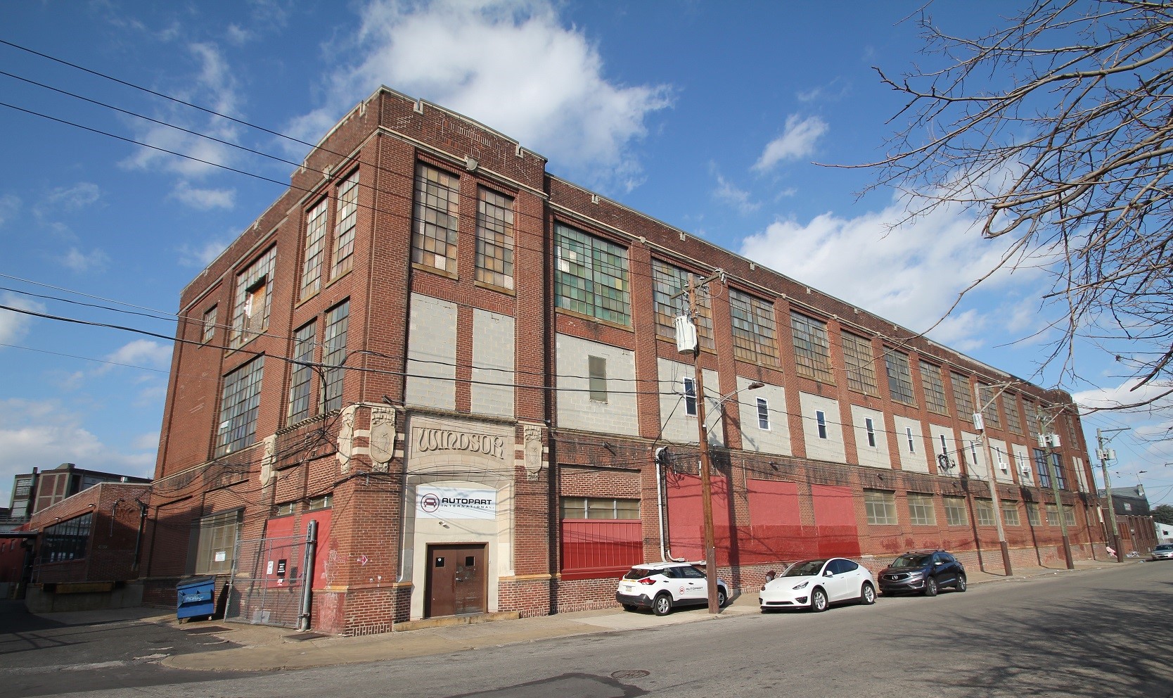 Large three-story brick building with many large industrial windows.