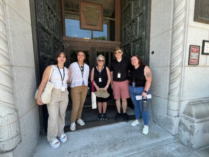 Group of people standing in a large doorway.