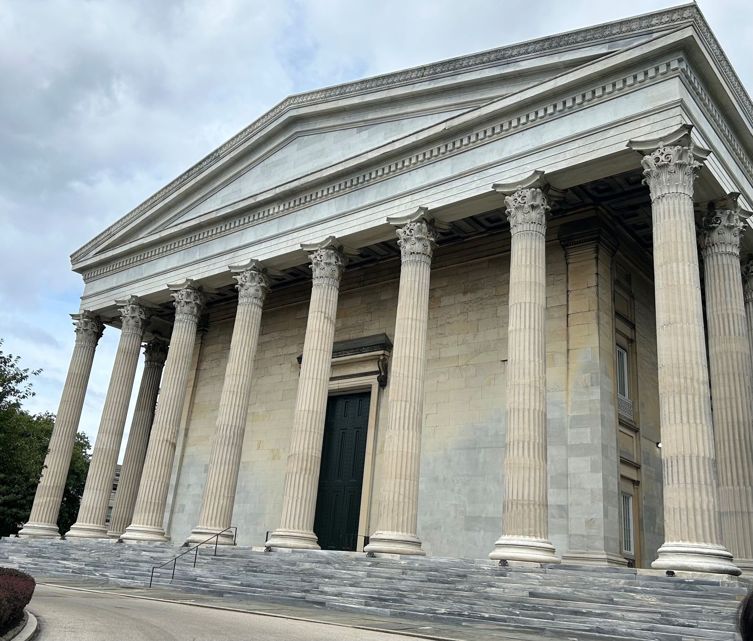 Large stone building with many tall columns.