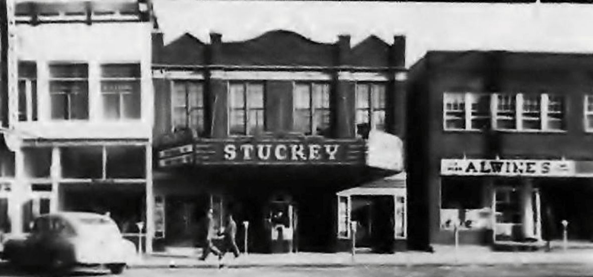 Old photo of theatre along main street.