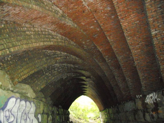 Bricks form the underside of a bridge.