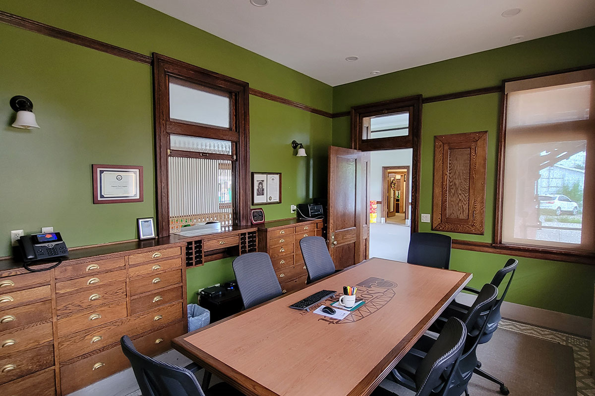 Small room with table, chairs, and built in cabinets.