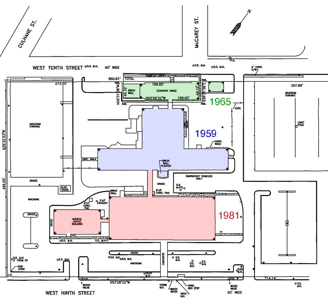 Map of property with red, blue, and green shading and dates in three buildings.