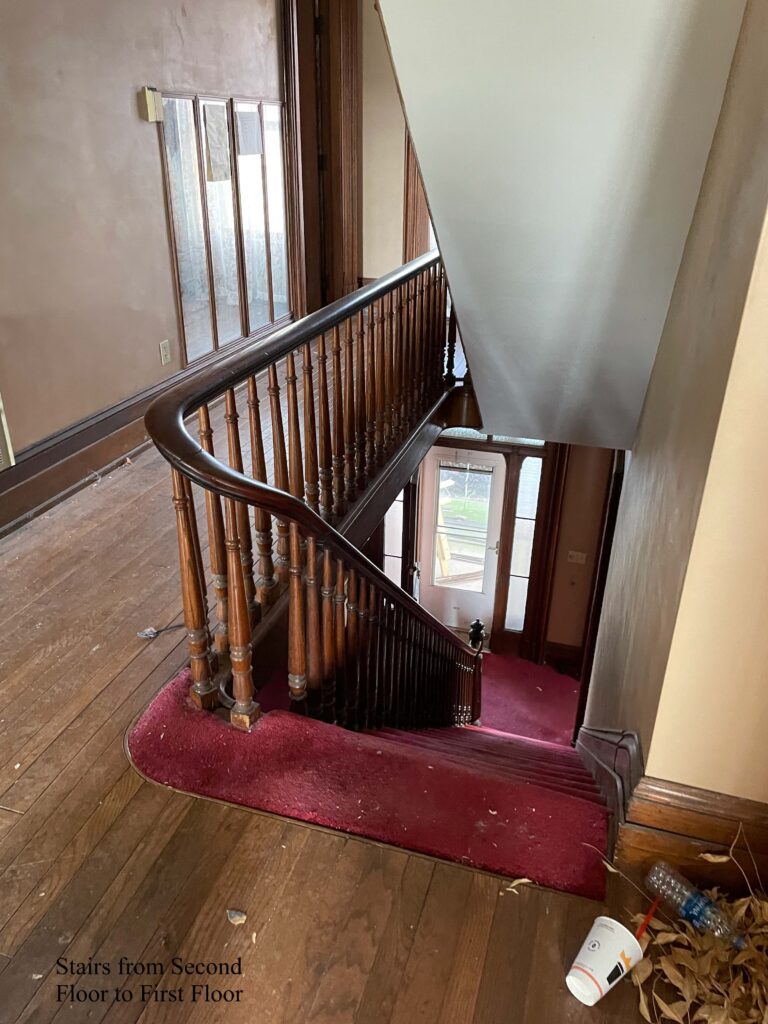 Narrow hallway on upper floor with stair to right.