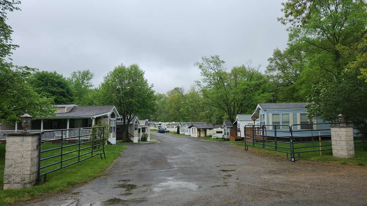 Looking along road through a neighborhood of small homes.