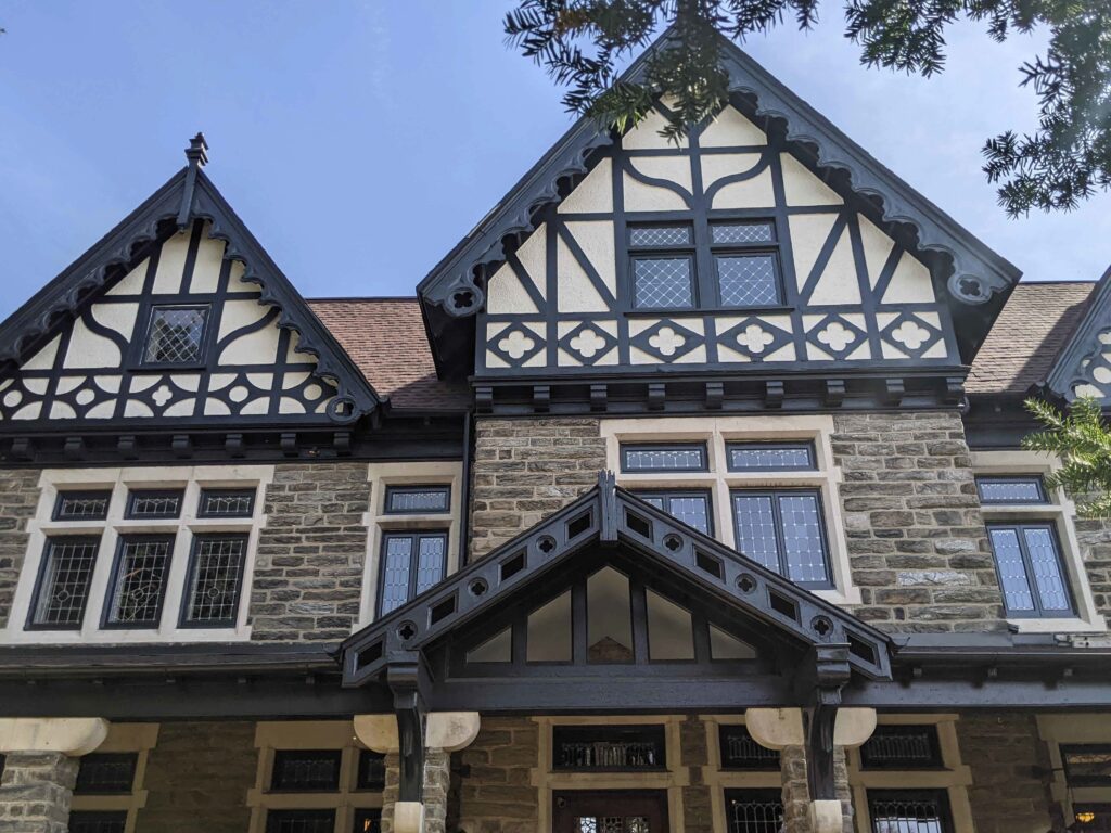 Decorative wood and stucco panels in roof gables.