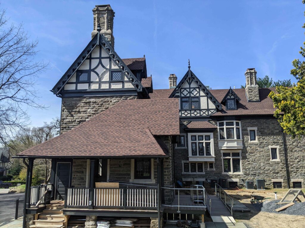 Large stone building with many rooflines.