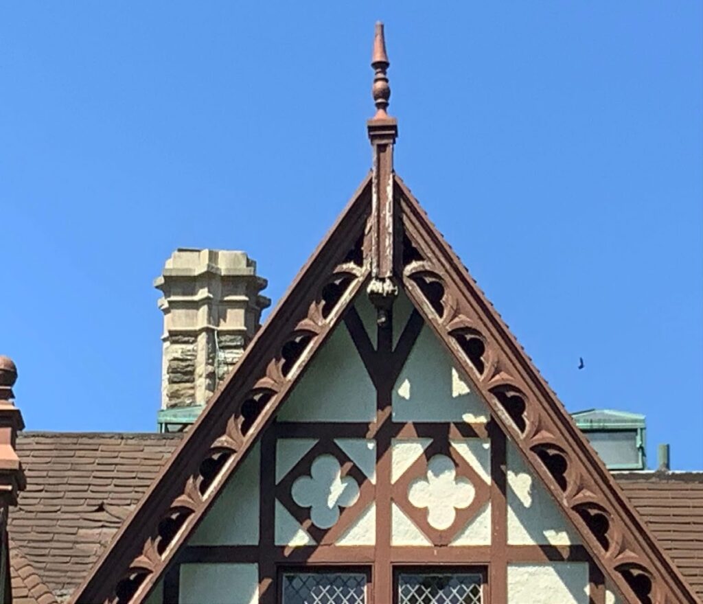 Steep roof gable with decorative boards and wall surface.