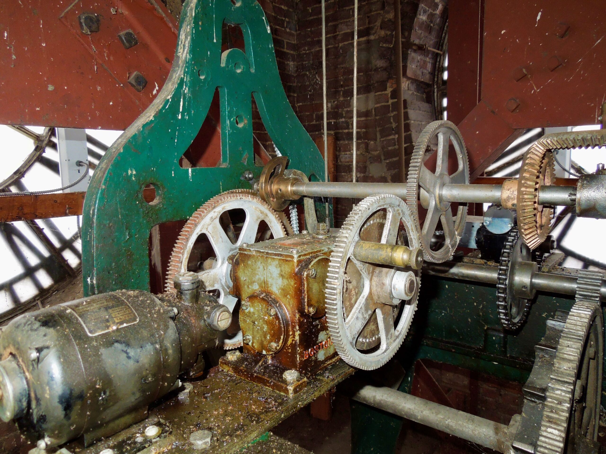 Gears and metal parts of a large old clock.