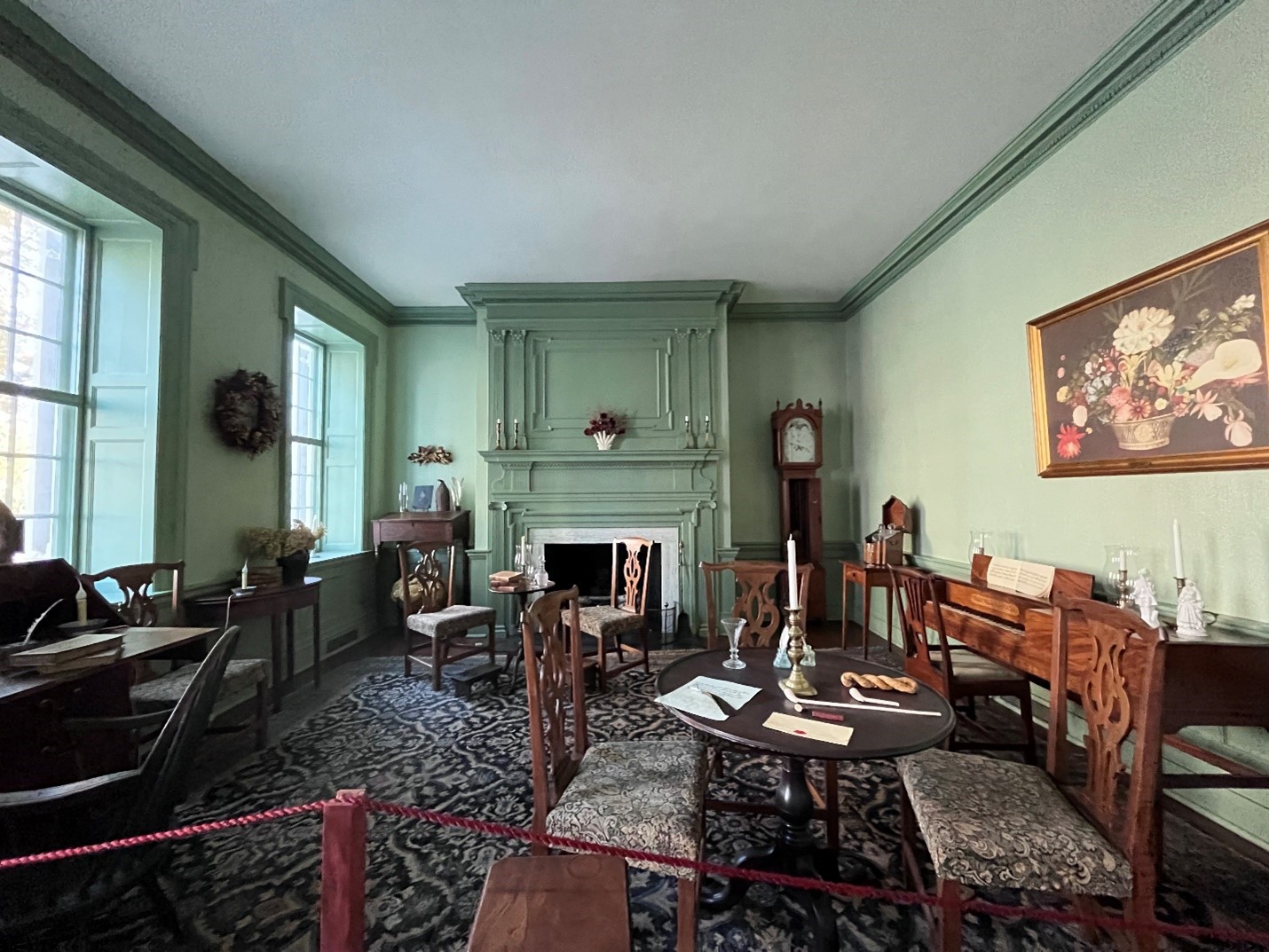 Room with several tables and chairs, a fireplace, and other furnishings.