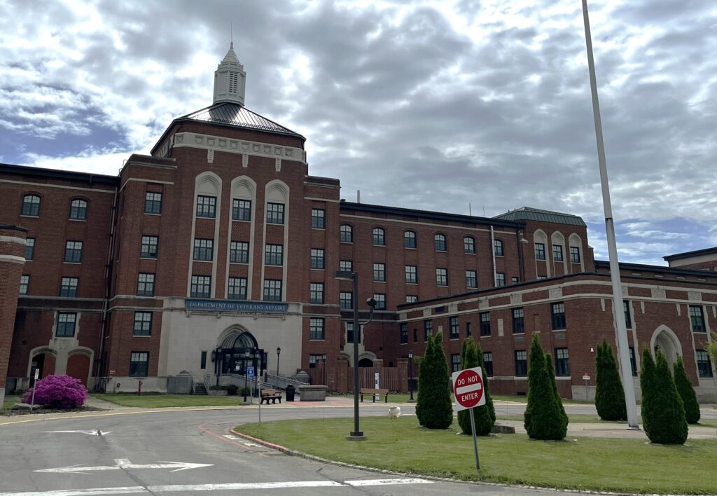 Large five-story brick building with many rows of windows and stone detailing.