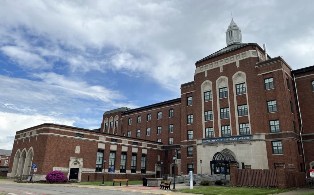 Large five-story brick building with many rows of windows and stone detailing.