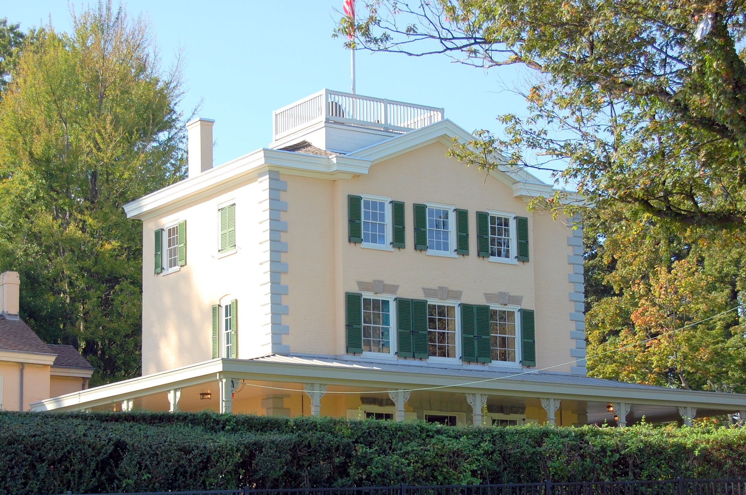 Large three-story residential building with stucco walls and many windows.