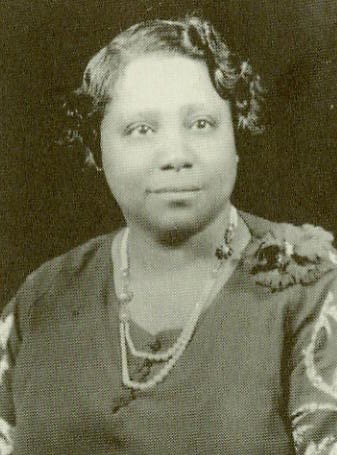 Portrait of a woman in early 20th century clothing.