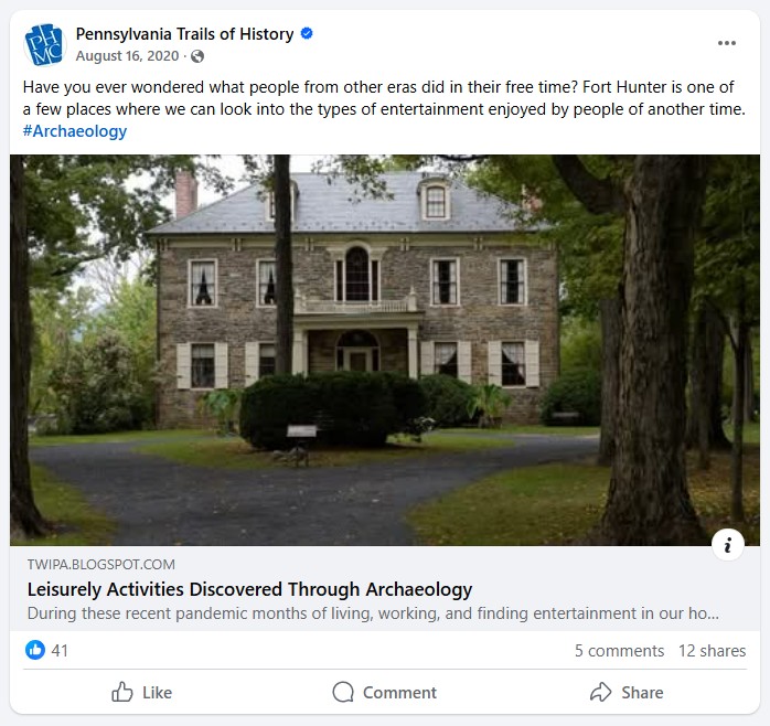 Facebook post with text above and below the image of a large stone house.