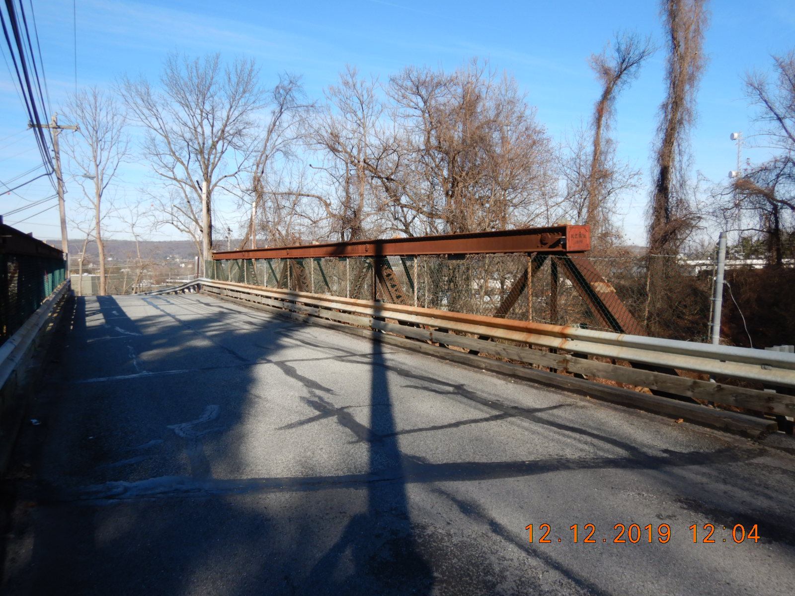 Rusty metal bridge carrying a paved surface.