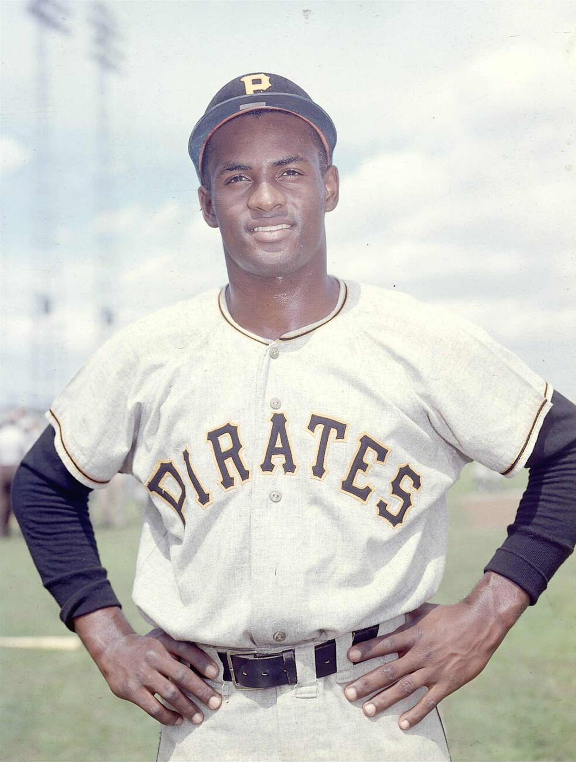 Man standing outside wearing a baseball uniform.