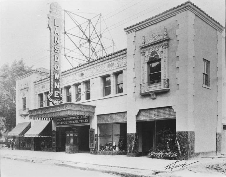 Black and white photograph of large building with many large windows, many decorative details, two square towers at either end, and a large vertical sign Lansdowne.